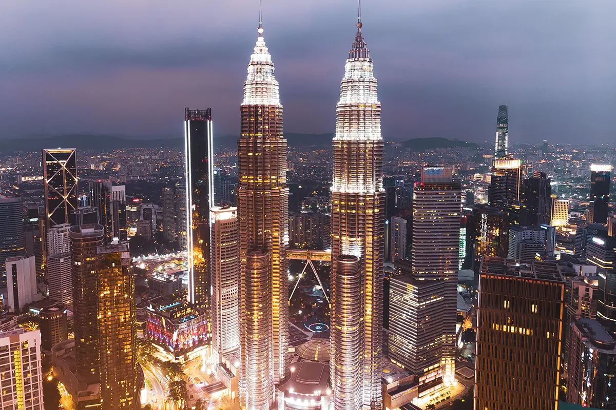 Kuala Lumpur skyline at dusk, representing Malaysia as the central economic hub and premier headquarters for the global Halal industry.